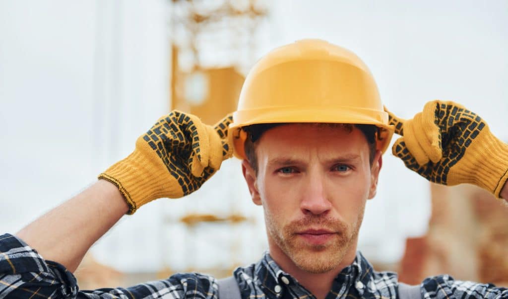 Portrait of construction worker in uniform and safety equipment